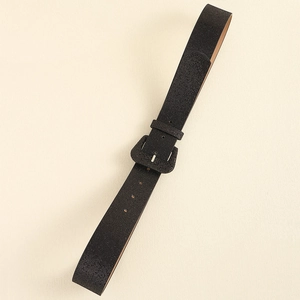 Close-up of black Y2K glitter belt with square buckle and textured matte finish on jeans