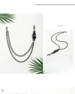 Detail of silver skull punk pant chain with thick double layers and lobster clasps