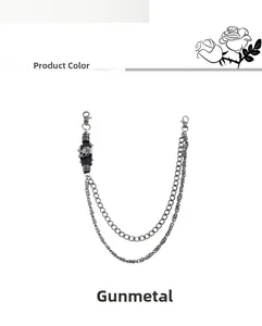 Detail of gunmetal punk trousers chain featuring double layers and a skull charm