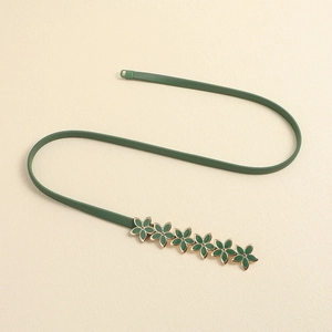 Detail of dark green elastic belt with gold-edged flower chain and ribbed texture