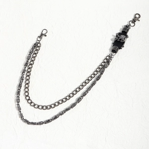 Detail of gun-black double-layer punk pants chain with silver skull relief decoration