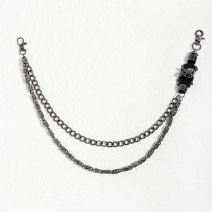 Close-up of punk style double-layer gunmetal trousers chain with a skull charm