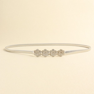 Detail of silver elastic metal belt featuring four hollow floral buckle patterns for women