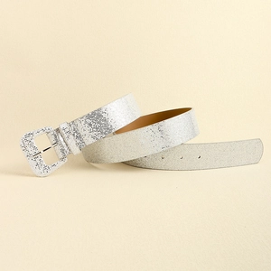 Detail of silver sequin Y2K belt with matching buckle on a beige textured background