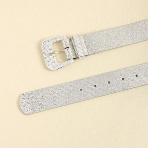 Close-up of a silver glitter Y2K belt with a matching square buckle on a textured background
