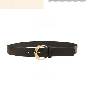 Detailed macro view of black leather belt with golden crescent-shaped metal buckle