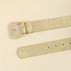 Detail of glitter sequins gold Y2K belt featuring metallic texture and square pin buckle