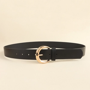 Detail of black leather belt featuring a vintage gold crescent buckle and smooth texture