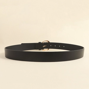Classic black leather belt with a polished gold horseshoe buckle in a minimalist style