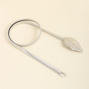 Detail of silver elastic metal waist chain with elegant leaf shaped buckle for dresses