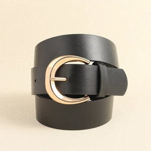 Women's black leather belt with gold crescent buckle in minimalist vintage style