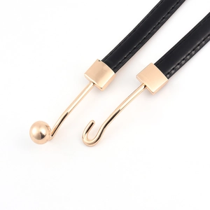 Elegant black leather waist belt with unique gold hook buckle for dresses and jackets