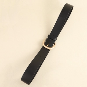 Detail of classic black studded leather belt featuring polished gold crescent metal buckle