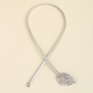 Detail of silver elastic metal waist belt featuring a delicate hollow leaf clasp design