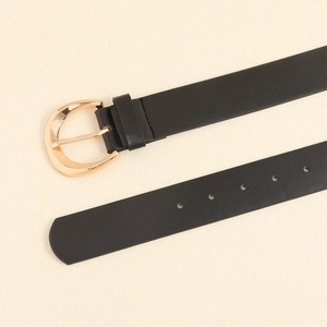 Detail of black leather belt with polished gold half-moon buckle and adjustment holes