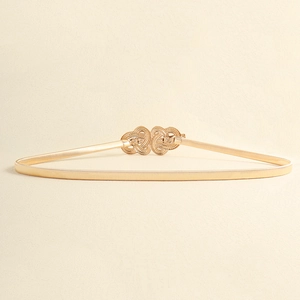 Close-up of golden elastic spring waist belt with butterfly style alloy buckle