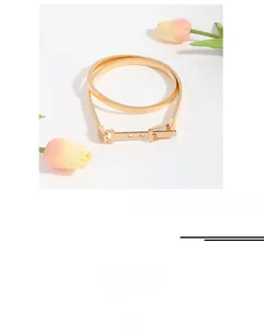 Detail of a 75cm gold elastic metal waist chain with a classic buckle for dresses