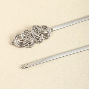 Detail of silver elastic metal waist chain featuring interlocking double heart buckle