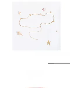 Detail of golden waist chain with leaf pendant and rhinestones, size 65+35cm