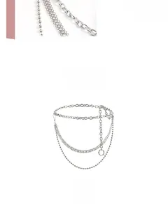 Detail view of multi-layered silver metal waist chain with adjustable ring link closure