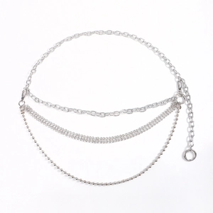 Detail view of a silver triple-layered metal waist chain with ball and lobster clasp links