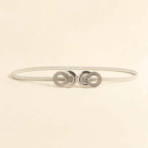 Detail of silver elastic metal belt with double ring buckle and textured finish