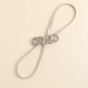 Close-up of silver elastic metal waist chain with interlocking buckle and matte texture