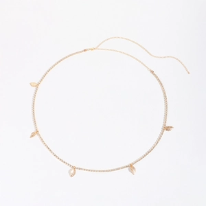 Detail of golden leaf pendant waist chain with sparkling rhinestones and lobster clasp