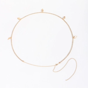 Detail view of a gold-tone waist chain with leaf pendants and sparkling rhinestones