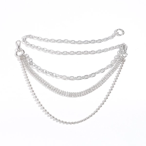 Detail view of multi-layered silver metal waist chain with diverse link styles and clasps