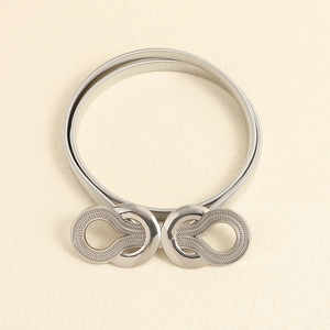 Detail view of silver stretch metal belt with interlocking textured double ring buckle