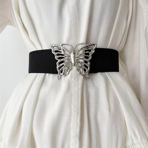 Elastic wide belt with large hollow silver butterfly buckle on white dress for women