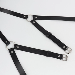 Detailed view of punk black PU leather body harness with silver O-rings and metal studs