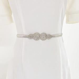 Detail of silver elastic metal waist chain with textured circular decorative elements