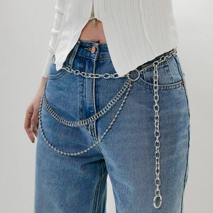 Detail of multi-layer silver metal waist chain with chunky rings and bead links for jeans