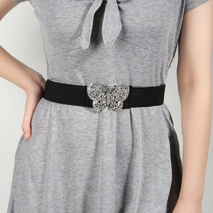 Close-up of black elastic waist belt with a sparkling silver rhinestone butterfly buckle