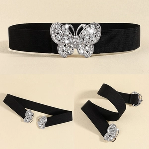 Detail of a black elastic belt featuring a silver butterfly buckle with sparkling rhinestones
