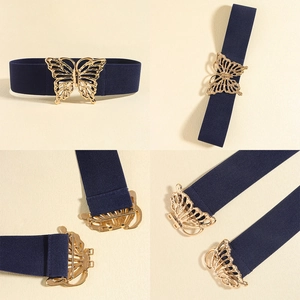 Detail view of elastic waist belt with hollow butterfly gold metal buckle in dark blue