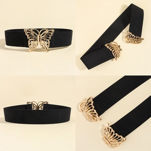 Close-up of black elastic waist belt featuring a decorative golden hollow butterfly buckle