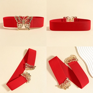Detail of red elastic waist belt featuring a large hollow golden butterfly buckle