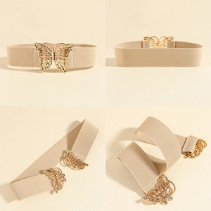 Close-up of beige elastic corset belt with a decorative golden cutout butterfly buckle