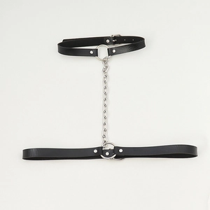 Detail of black punk leather body chain featuring silver metal links and adjustable buckles