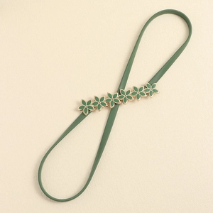 Forest green elastic metal waist belt featuring decorative gold-trimmed enamel flowers