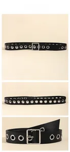 Close-up detail of black punk leather belt featuring silver metal eyelets and square buckle