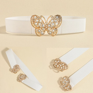 Close-up of white elastic waist belt featuring a gold butterfly buckle with rhinestones