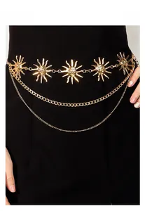 Detail showing triple-layer golden sunflower waist chain on a black dress backdrop