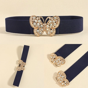 Detail of navy blue elastic waist belt with sparkling rhinestone butterfly metal buckle