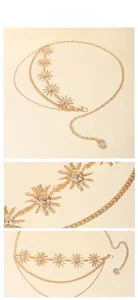 Detail of bohemian gold sun pendants and layered chain on an adjustable waist belt