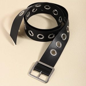 Close-up of black leather belt with silver grommets and polished square metal buckle