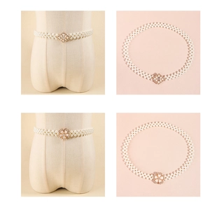 Detail view of pearl elastic waist belt featuring sparkling rhinestone flower buckle designs